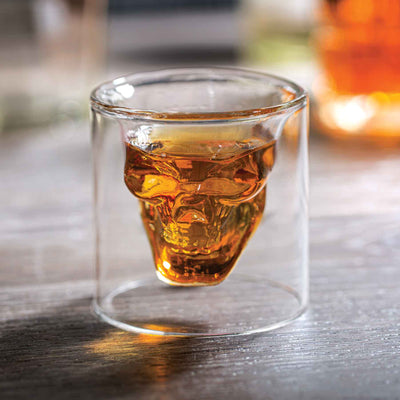skull shaped shot glass with whiskey